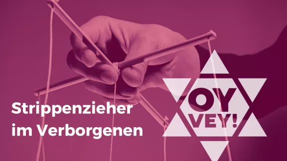 Hand hält Marionettenkreuz
