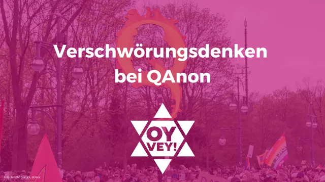 Schild mit einem brennenden Q der QAnon-Bewegung